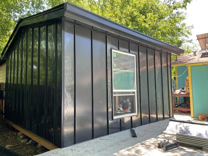 Black standing seam metal wall panels for Roof Inspection in Horizon West